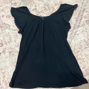 Black scoop neck house with sleeve pom pom detail